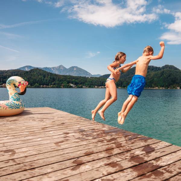 Kinder springen vom Steg in den Klopeiner See